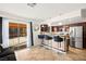 Kitchen and bar area with stainless steel appliances and dark wood cabinets at 5717 Christchurch Ave, Las Vegas, NV 89110