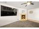 Well-lit living room offering a fireplace and a large television for entertainment at 5717 Christchurch Ave, Las Vegas, NV 89110