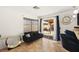 Cozy seating area with a black sofa and sliding glass doors leading to the backyard at 5717 Christchurch Ave, Las Vegas, NV 89110