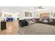 Bright and airy living room with a large sectional couch and open access to the dining area at 5717 Christchurch Ave, Las Vegas, NV 89110