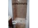 A bathroom with a standup shower and a tiled wall at 6225 Factor Ave, Las Vegas, NV 89107