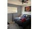 Bedroom with a dark bed and window for natural light at 6225 Factor Ave, Las Vegas, NV 89107