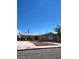 Charming single-story home featuring a well-maintained front yard and a spacious driveway under a clear blue sky at 6225 Factor Ave, Las Vegas, NV 89107
