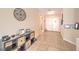 Warm entryway with tile flooring, a console table, decorative wall art, and bright lighting at 6429 White Tiger Ct, Las Vegas, NV 89130