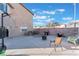 Large backyard featuring a concrete patio, brick walls, a fire pit, and an outdoor grill at 6552 Casamar St, North Las Vegas, NV 89086