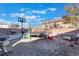 Backyard featuring a trampoline, grill, and a basketball hoop surrounded by brick walls at 6552 Casamar St, North Las Vegas, NV 89086