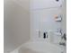 Bathroom with an all-white tiled shower and soaking tub with inset shelving at 6552 Casamar St, North Las Vegas, NV 89086