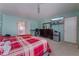 Bedroom with bright green wallpaper, large bed, TV, and mini-fridge at 6552 Casamar St, North Las Vegas, NV 89086