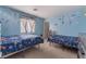 Brightly decorated bedroom with twin beds and blue toy-themed wallpaper at 6552 Casamar St, North Las Vegas, NV 89086