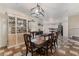 Elegant dining area featuring a display cabinet, table set for six, and contemporary lighting at 6552 Casamar St, North Las Vegas, NV 89086