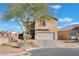Inviting two-story home featuring a two-car garage, landscaped front yard, and neutral stucco exterior at 6552 Casamar St, North Las Vegas, NV 89086