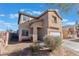 Attractive two-story home with a welcoming front entrance, desert landscaping, and attached garage at 6552 Casamar St, North Las Vegas, NV 89086