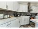 Contemporary kitchen with white cabinets, modern appliances, and sleek countertops for a stylish cooking space at 6552 Casamar St, North Las Vegas, NV 89086