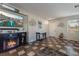 Cozy living room featuring tile floors, a fireplace, and a TV for entertainment and relaxation at 6552 Casamar St, North Las Vegas, NV 89086