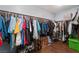 Walk-in closet complete with shelves and a variety of shoes and clothing at 6552 Casamar St, North Las Vegas, NV 89086