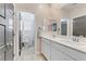 Modern bathroom with double sinks, contemporary fixtures, and neutral tones, offering a clean and stylish design at 7122 Red Gulch St, North Las Vegas, NV 89084