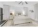 Cozy bedroom with white walls, a plush bed, and natural light from large windows at 7122 Red Gulch St, North Las Vegas, NV 89084