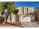 Charming two-story home boasts a well-maintained front yard and classic architectural details under a clear blue sky at 7228 Buglehorn St, Las Vegas, NV 89131