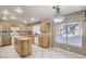Bright kitchen featuring an island, ample cabinetry, modern appliances, and an adjacent dining area at 7228 Buglehorn St, Las Vegas, NV 89131