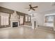 Bright living room featuring neutral tile flooring, fireplace, large windows, and an airy open floor plan at 7228 Buglehorn St, Las Vegas, NV 89131