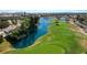 Stunning aerial view of a community with lush green golf course, water features, and beautiful homes nearby at 7772 Buckwood Ct, Las Vegas, NV 89149