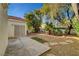 Low maintenance backyard with mature landscaping, stone accents, and concrete patio space at 7772 Buckwood Ct, Las Vegas, NV 89149