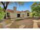 Enclosed backyard displays mature trees, patio area, and access to the main building at 7772 Buckwood Ct, Las Vegas, NV 89149