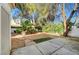 Private backyard featuring mature trees, gravel cover, concrete patio, and serene landscaping at 7772 Buckwood Ct, Las Vegas, NV 89149