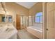 Bathroom featuring double sinks, shower and separate tub at 7772 Buckwood Ct, Las Vegas, NV 89149