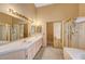 Primary bathroom featuring double sinks, separate shower and tub at 7772 Buckwood Ct, Las Vegas, NV 89149