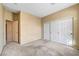 Neutral bedroom features a carpet floor, closet, and an adjacent entry door at 7772 Buckwood Ct, Las Vegas, NV 89149