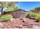 Community entrance sign 'Painted Desert' surrounded by flowers, bushes, and rocks at 7772 Buckwood Ct, Las Vegas, NV 89149
