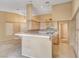 Bright kitchen featuring a tile countertop breakfast bar, white cabinets, and modern appliances at 7772 Buckwood Ct, Las Vegas, NV 89149