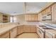 Kitchen features tile countertops, ample cabinet space, and a breakfast bar at 7772 Buckwood Ct, Las Vegas, NV 89149