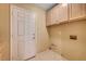 Practical laundry room features overhead cabinets and convenient washer-dryer hookups at 7772 Buckwood Ct, Las Vegas, NV 89149