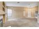 Spacious living room with carpet flooring, a fireplace, and an open layout at 7772 Buckwood Ct, Las Vegas, NV 89149