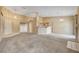 Open concept living room with carpet flooring, open to kitchen area and fireplace at 7772 Buckwood Ct, Las Vegas, NV 89149