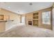 Well-lit living room with sliding glass doors and built-in shelving next to a fireplace at 7772 Buckwood Ct, Las Vegas, NV 89149