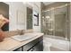 Bathroom featuring a modern vanity, framed mirror, and a glass enclosed shower-tub combo at 80 Pristine Glen St, Las Vegas, NV 89135