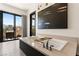 This modern bathroom features a soaking tub, a balcony with a view, and contemporary lighting at 80 Pristine Glen St, Las Vegas, NV 89135