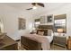 Comfortable bedroom boasts stylish decor, including modern art, a ceiling fan, and coordinated furnishings at 80 Pristine Glen St, Las Vegas, NV 89135