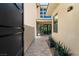 Inviting entryway features a stone walkway, modern planters, and a glimpse of the interior through glass doors at 80 Pristine Glen St, Las Vegas, NV 89135