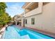 Modern home exterior showcasing a refreshing pool, covered patio, and upper level balcony at 80 Pristine Glen St, Las Vegas, NV 89135