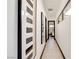 Bright hallway features tile flooring, modern art, and leads to a bedroom with lots of natural light at 80 Pristine Glen St, Las Vegas, NV 89135