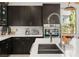 Modern kitchen featuring dark cabinets, stainless steel appliances, and a large island with a sink at 80 Pristine Glen St, Las Vegas, NV 89135
