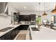 Spacious kitchen with dark cabinets, white countertops, stainless steel appliances, and a large island at 80 Pristine Glen St, Las Vegas, NV 89135