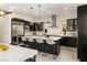 Gourmet kitchen features bar seating, stainless appliances, and a seamless design connecting to the dining area at 80 Pristine Glen St, Las Vegas, NV 89135