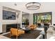 The living room features a stylish chandelier and comfortable seating, with seamless access to the outdoor living space at 80 Pristine Glen St, Las Vegas, NV 89135