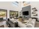 Open-concept living area with a modern fireplace and seamless transition to an outdoor pool and entertainment space at 80 Pristine Glen St, Las Vegas, NV 89135