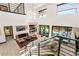 Open-concept living space features high ceilings, a modern chandelier, and a view of the pool from the upper level at 80 Pristine Glen St, Las Vegas, NV 89135